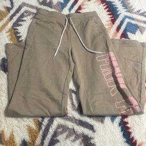 Tan comfy wide leg pants with “PINK FLOYD” on the side in pink letters.